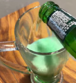 Green beer in a clear glass for a St. Patrick’s Day at home celebration